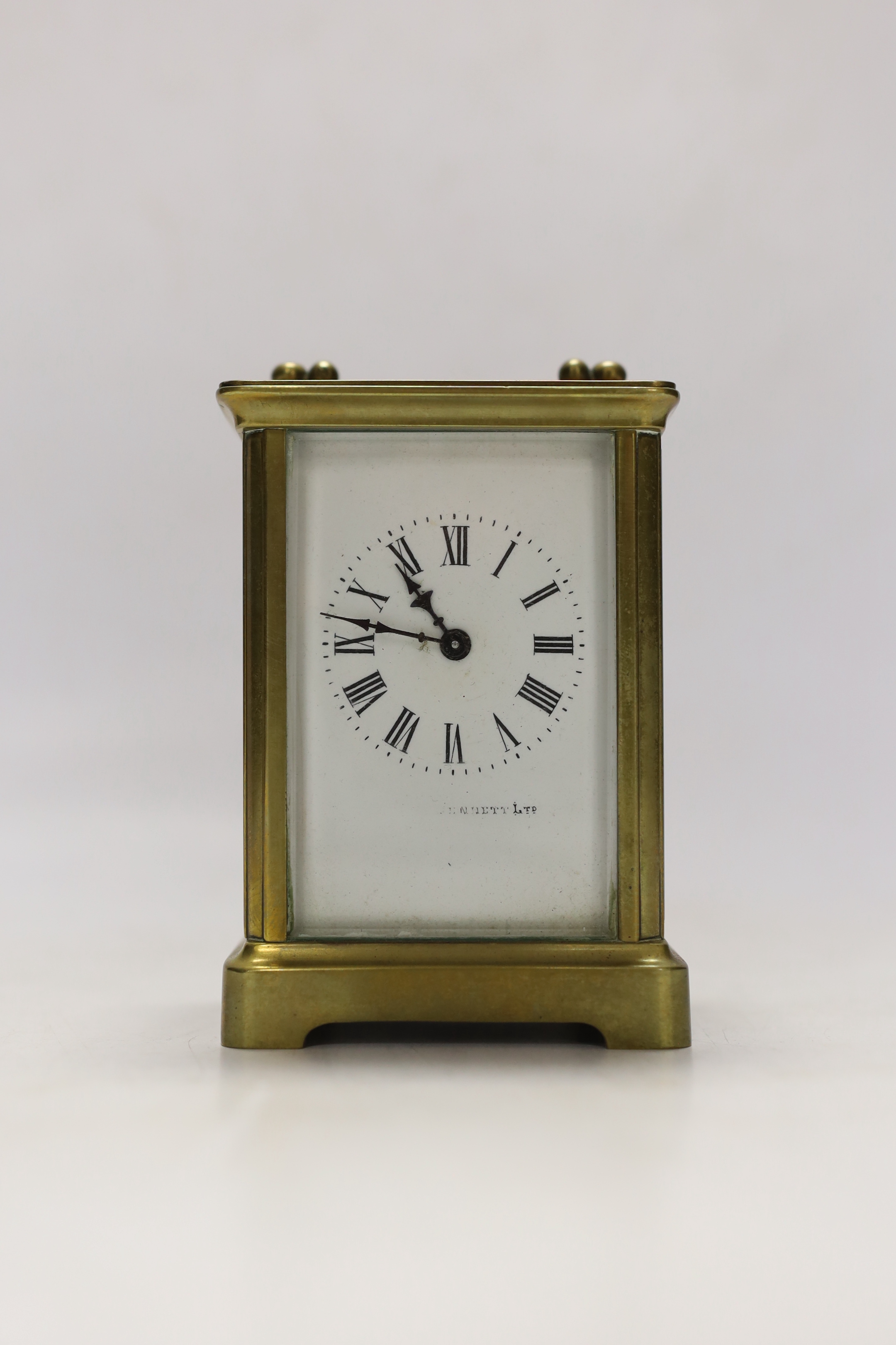 An early 20th century French lacquered brass carriage clock, cased